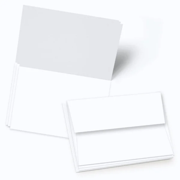 Blank white greeting cards stacked together, showcasing both card and envelope.