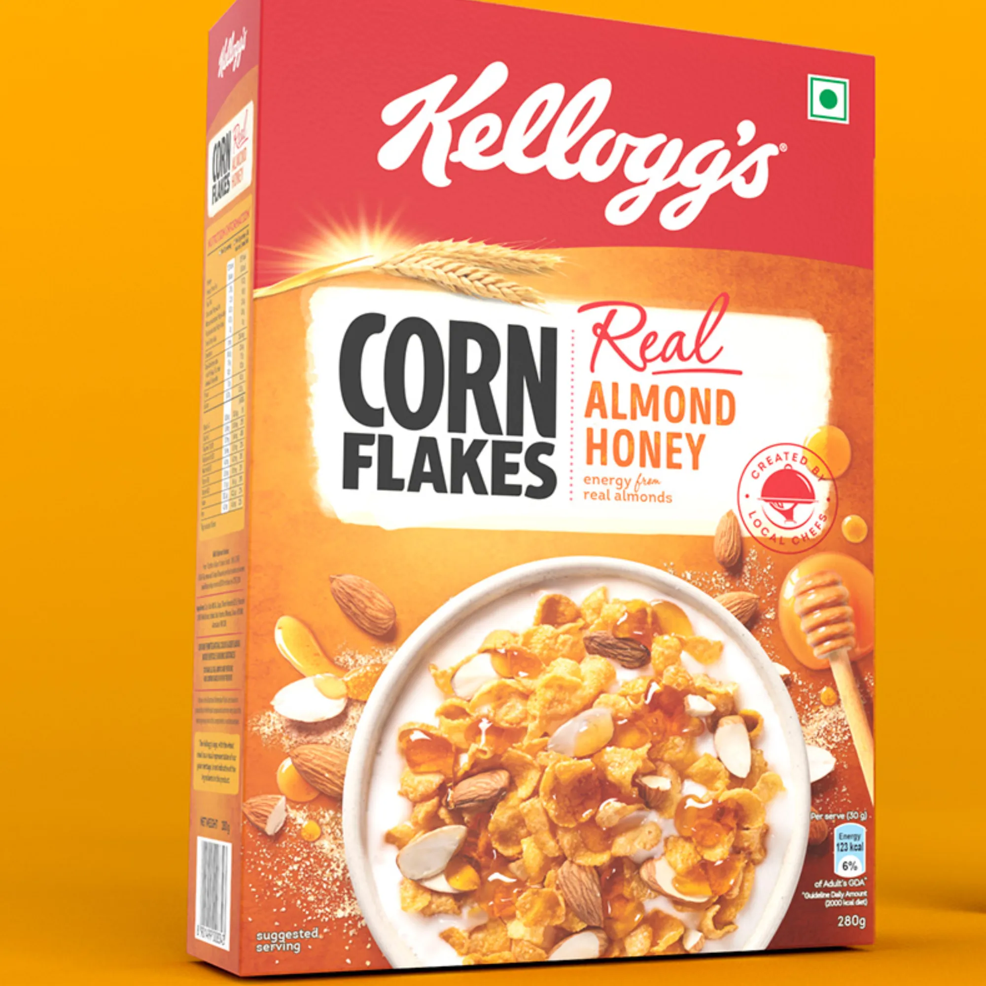 Kellogg's Corn Flakes box featuring Real Almond Honey with a bowl of corn flakes on the front.