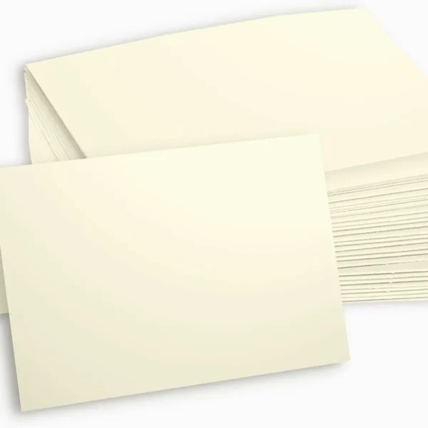 Cream-colored greeting cards stacked neatly, highlighting their blank design.