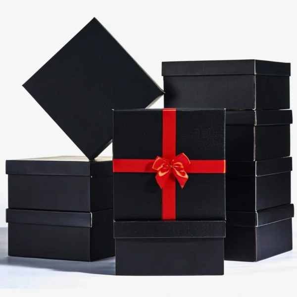 Elegant black gift boxes with a red ribbon and bow.