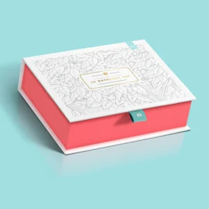 A stylish book-style rigid box with a white top featuring a leaf pattern, coral sides, and a teal ribbon tab for opening.