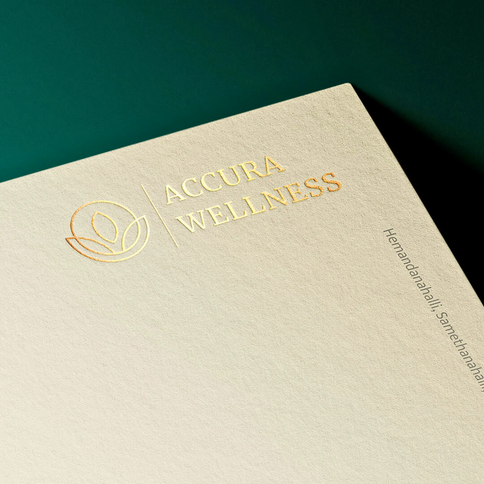 Close-up of a beige letterhead with "ACCURA WELLNESS" embossed in gold.