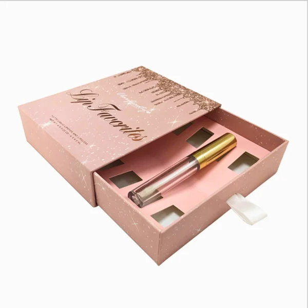 A pink box containing a lip gloss or lip oil.