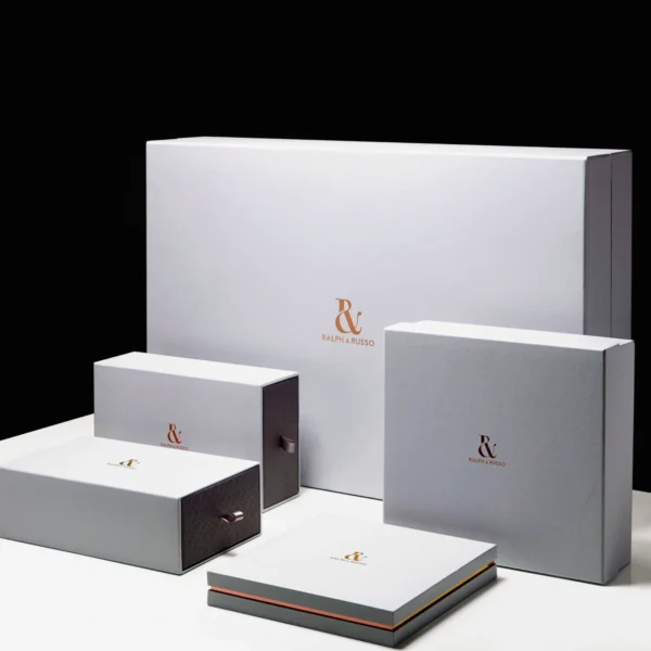 A set of minimalist white luxury boxes with elegant copper branding, designed for premium packaging.
