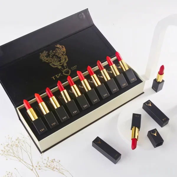 A set of red lipsticks in a black and gold box.