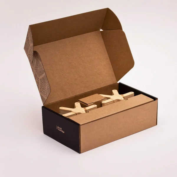 Custom PR box with a plain interior and wooden clips inside.